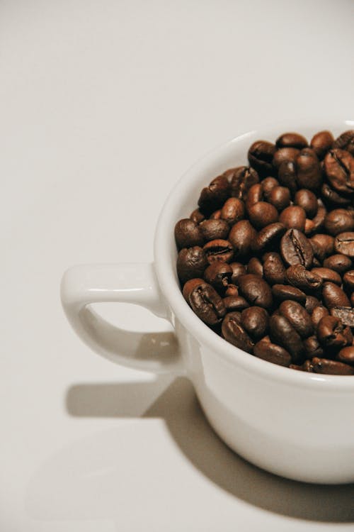 Coffee Beans in White Ceramic Cup