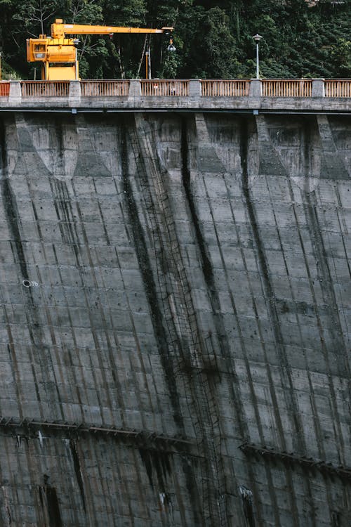 Yellow Crane on Concrete Water Dam