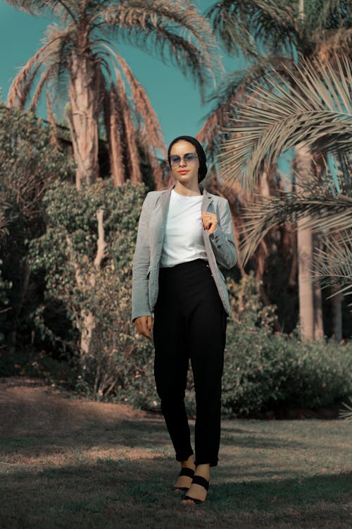 Woman in Gray Blazer Standing on Grass Field