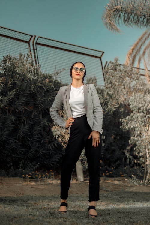 Woman in Gray Blazer Standing on Grass Field