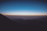 Breathtaking view of mountain silhouette against a vibrant sunrise sky.