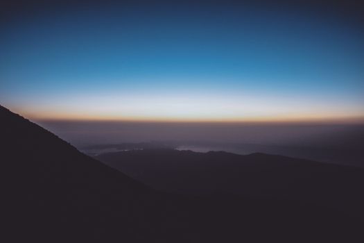 Breathtaking view of mountain silhouette against a vibrant sunrise sky.
