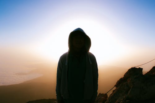 Silhouette of a Person Wearing Hoodie Jacket 
