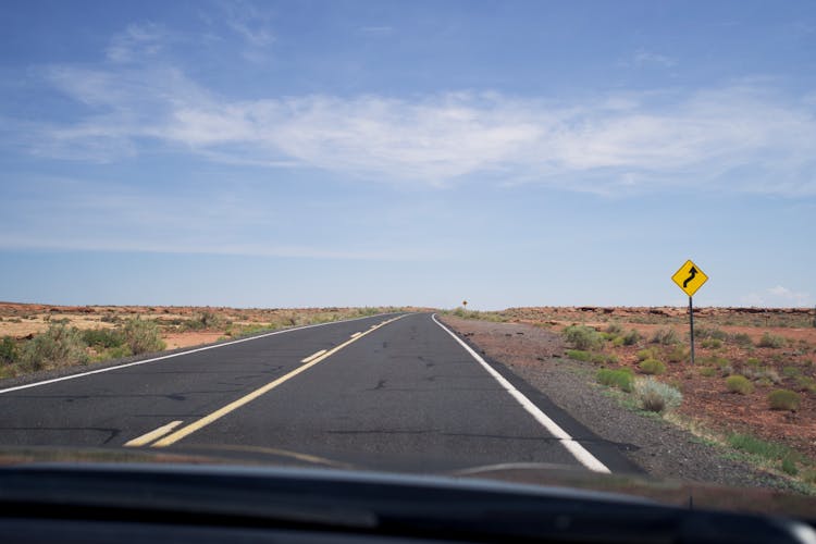 Driving On An Empty Asphalt Road Through The Desert