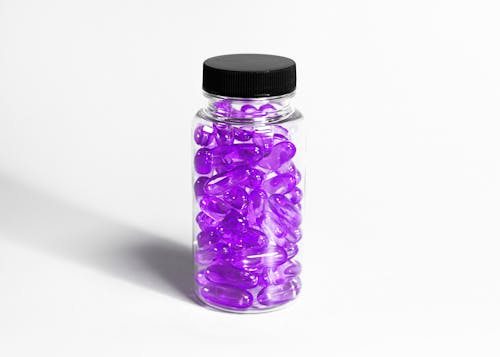 A Purple Pills on Glass Bottle