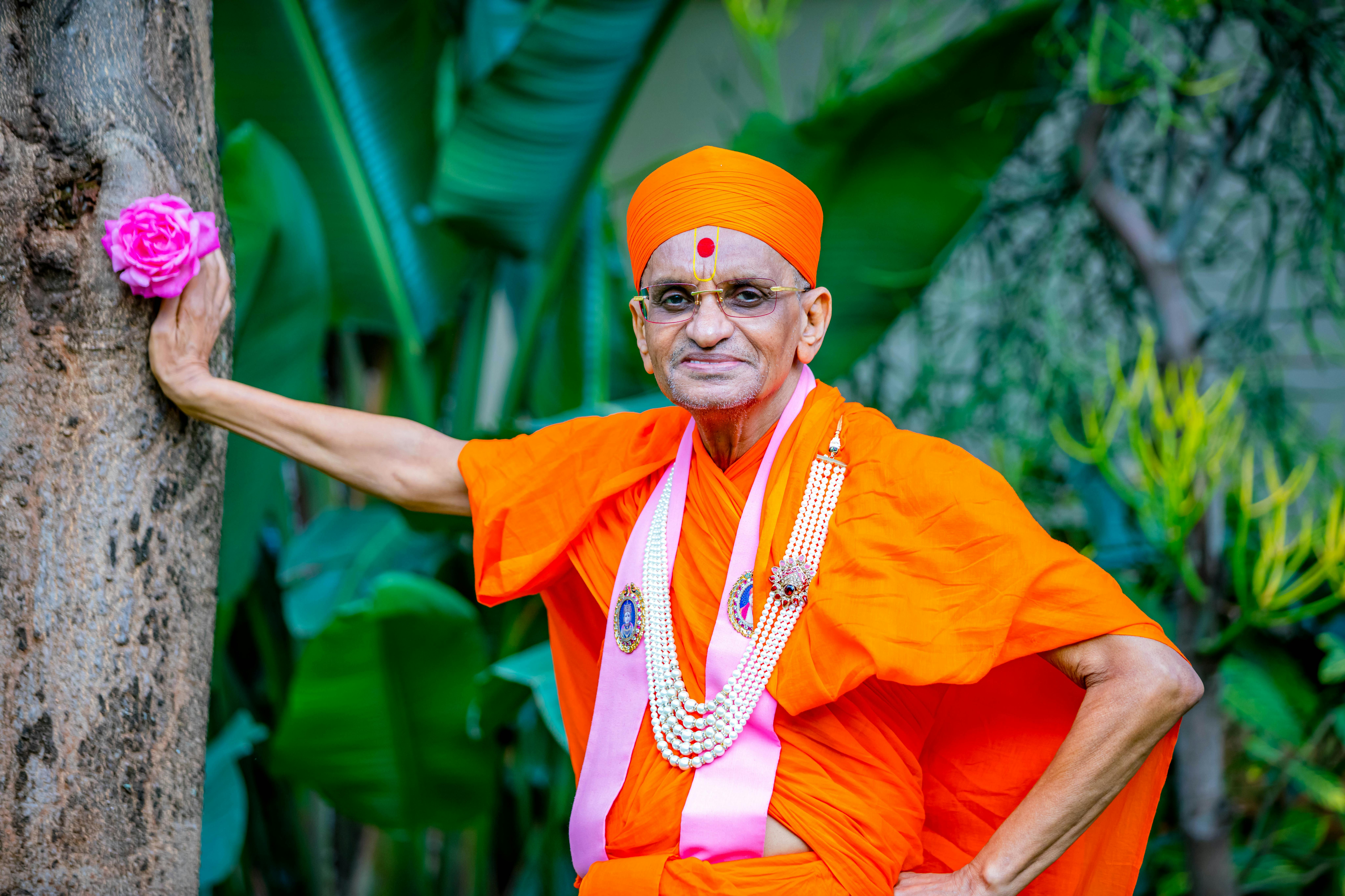 A Man in Orange Robe Looking at the Camera · Free Stock Photo