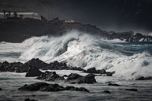 Photograph of Waves Crashing on Rocks