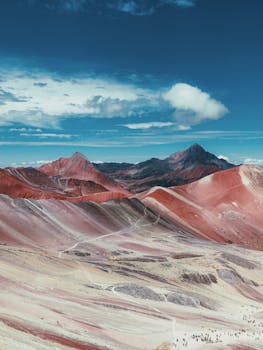 Breathtaking aerial view of the colorful Rainbow Mountain in Peru, showcasing vibrant layers of minerals.