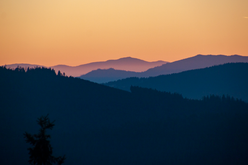 Free Serene mountain landscape during twilight with soft shades of blue and orange. Stock Photo