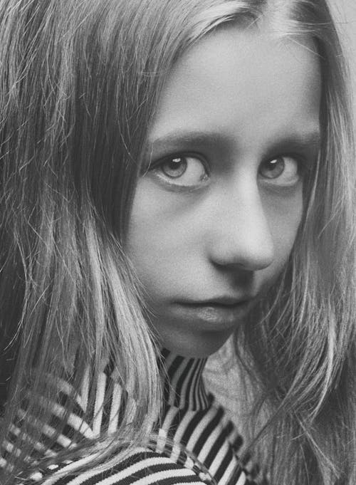 Grayscale Photo of a Girl in Black and White Stripe Shirt