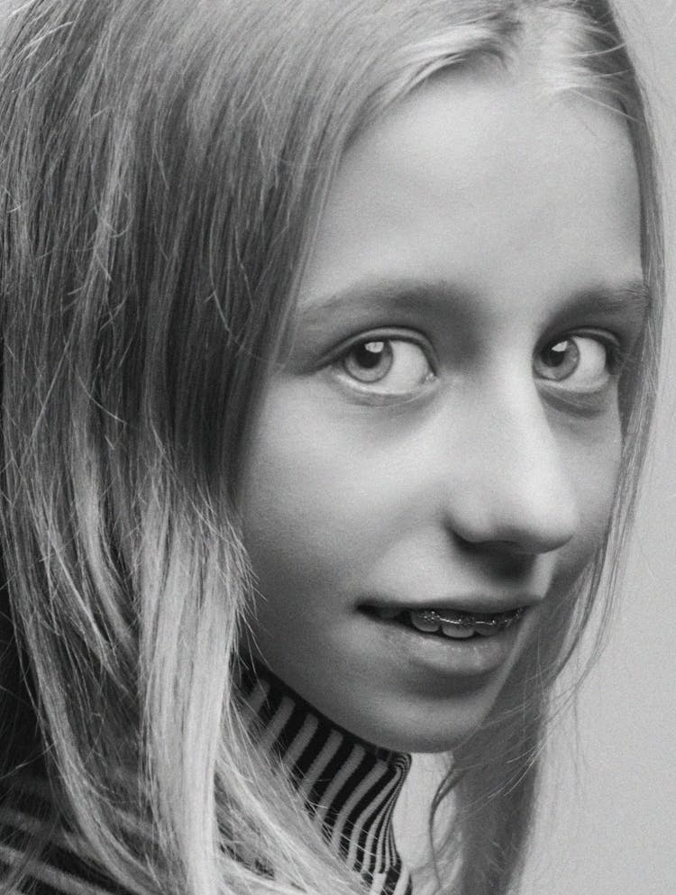 Grayscale Portrait Of A Girl With Braces 