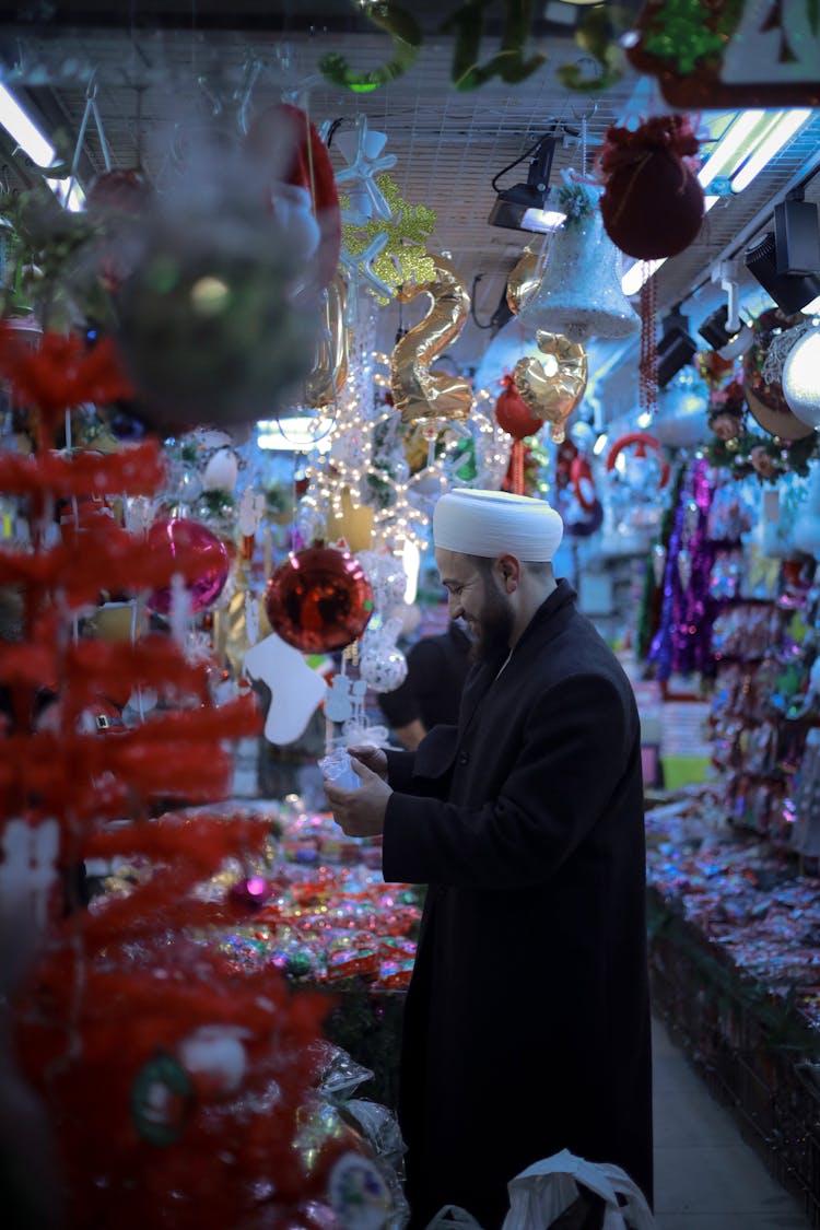 Man Standing In Store With Decorations