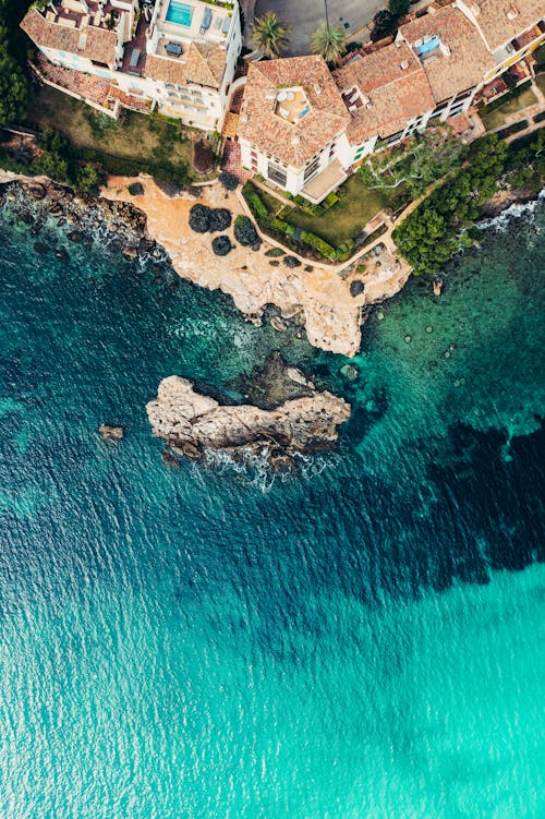 Houses by Rocky Beach on Ocean Shore