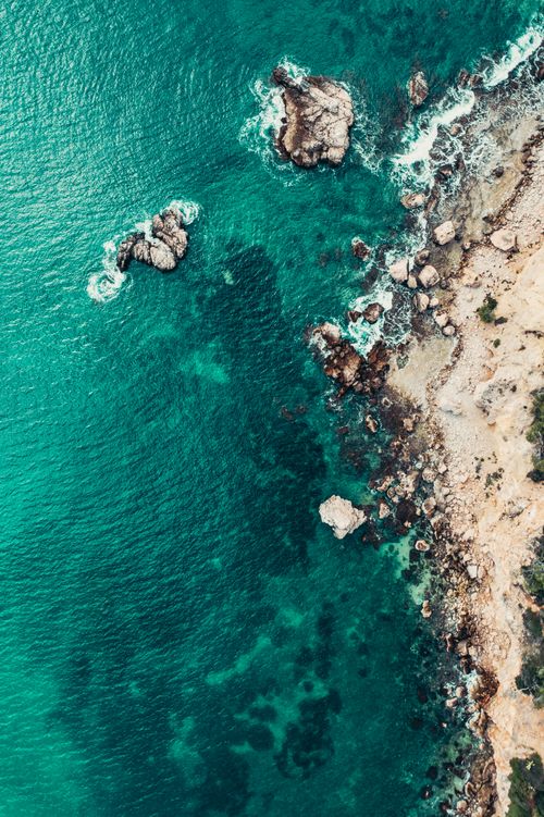 Free Explore the breathtaking aerial view of Palma's vibrant coastline with turquoise waters and rocky shores. Stock Photo