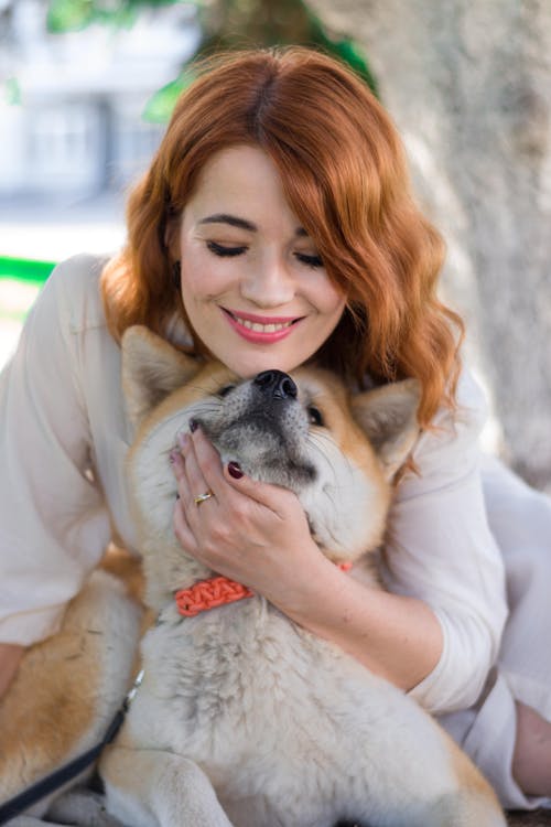 Portrait of Woman Hugging Shiba Inu Dog