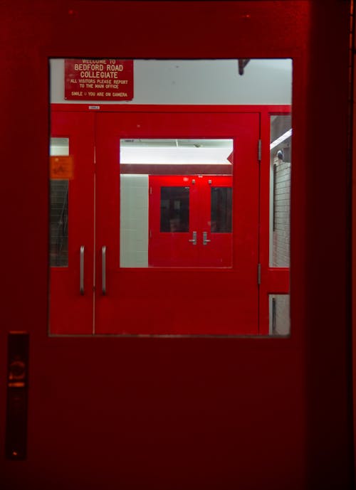 Red Double Doors of the Bedford Road Collegiate Entrance