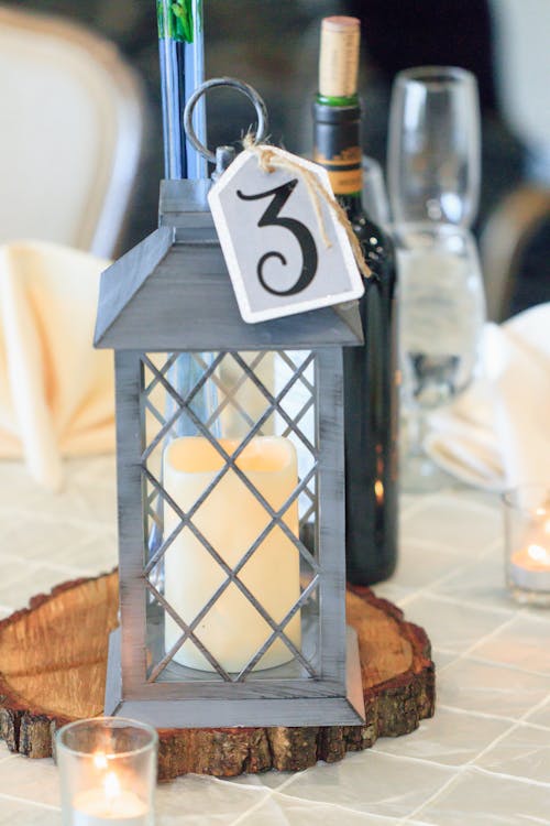 Selective Focus Photography of Candle Lantern on Table