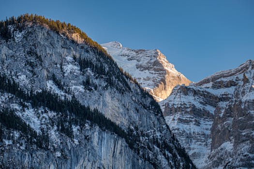Majestic snow-covered mountains under a clear blue sky, capturing the serene beauty of winter.