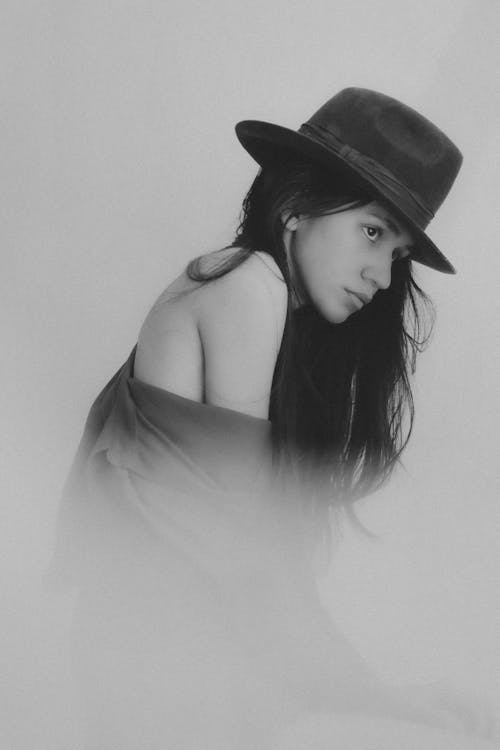 Grayscale Photo of Woman Wearing Black Hat