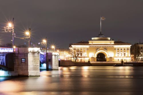 Free Stunning nighttime view of the illuminated Admiralty building in St. Petersburg, reflecting in the water. Stock Photo