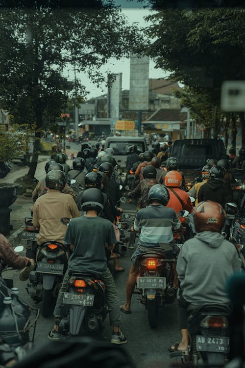 People Riding Motorcycles on Road