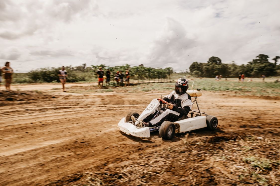 Cart Ride Real Life A Person Riding a Go Kart Strolling on a Muddy Track · Free Stock Photo