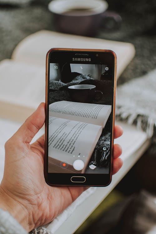 Person Taking Photo at Book