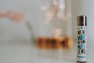 White Labeled Lighter Placed on White Surface