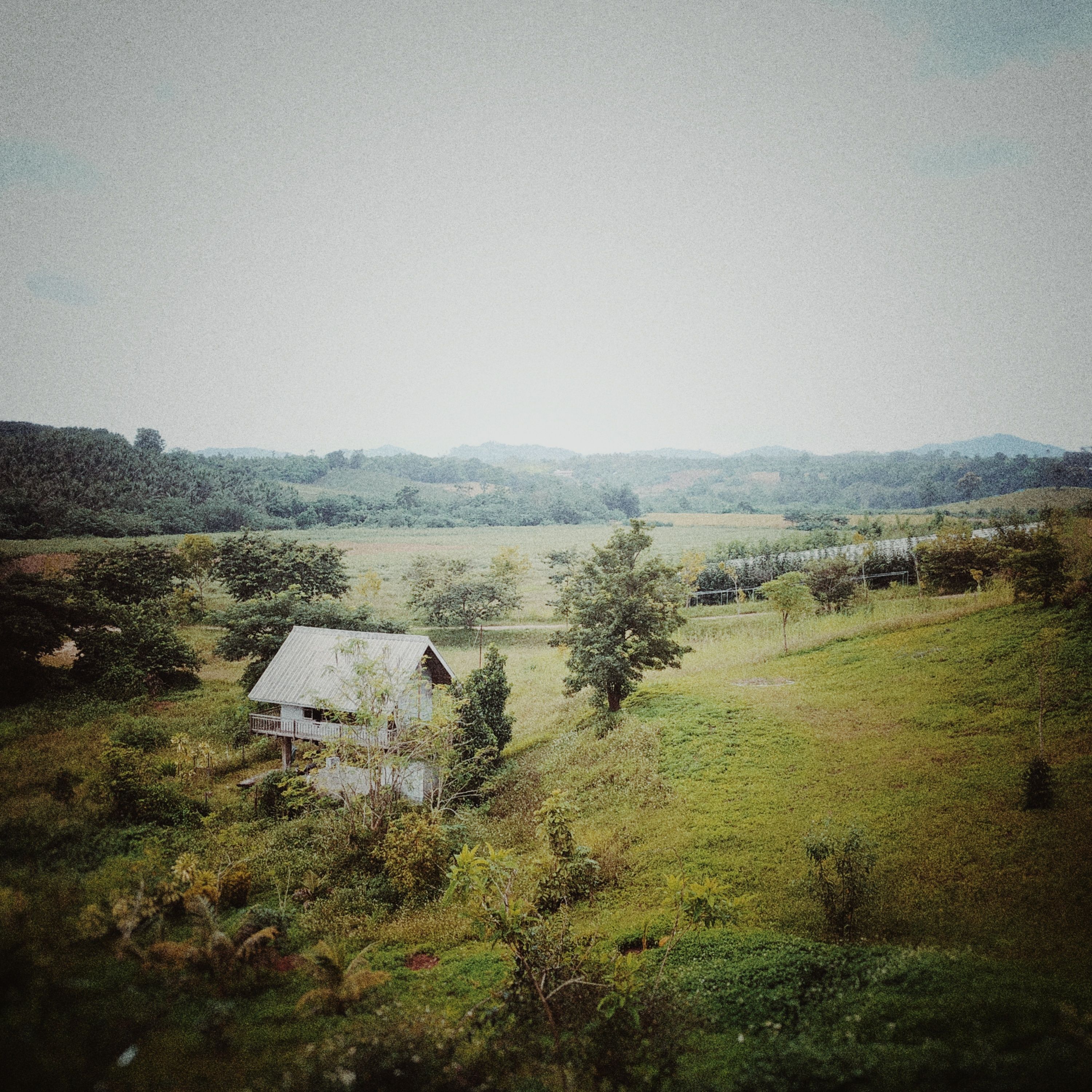 Green Field and Farmhouse on Hill · Free Stock Photo