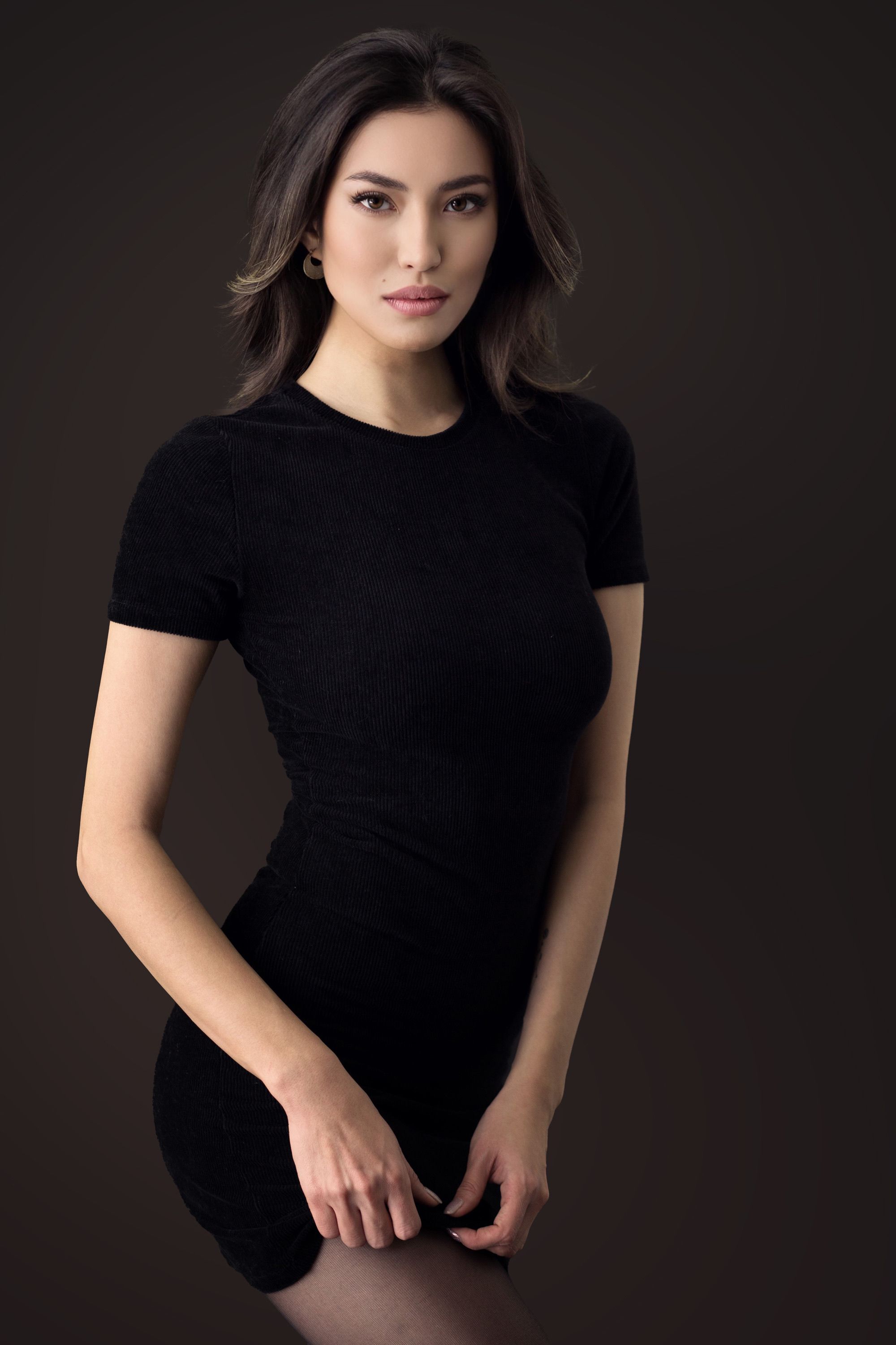 Stunning portrait of a woman in a black dress, shot in a studio setting.