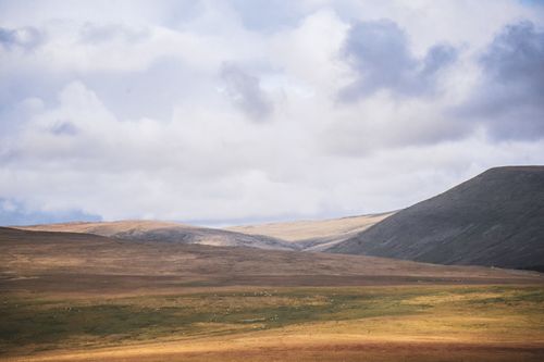 Free Expansive view of rolling hills and sky in Brecon Beacons National Park, Wales. Stock Photo