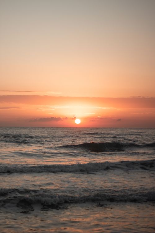 Free Capture the tranquil beauty of the ocean at sunrise in Mersin, Türkiye, with golden hues and gentle waves. Stock Photo