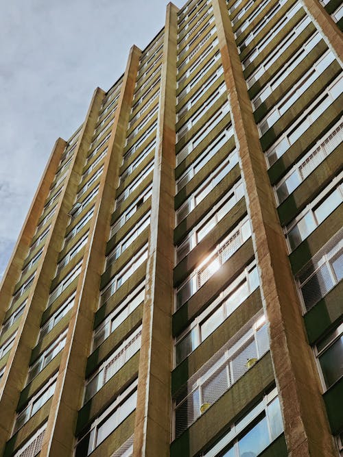 A Low Angle Shot of a Building with Glass Windows