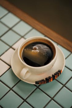 A cup of black coffee sits on a patterned table in Istanbul.