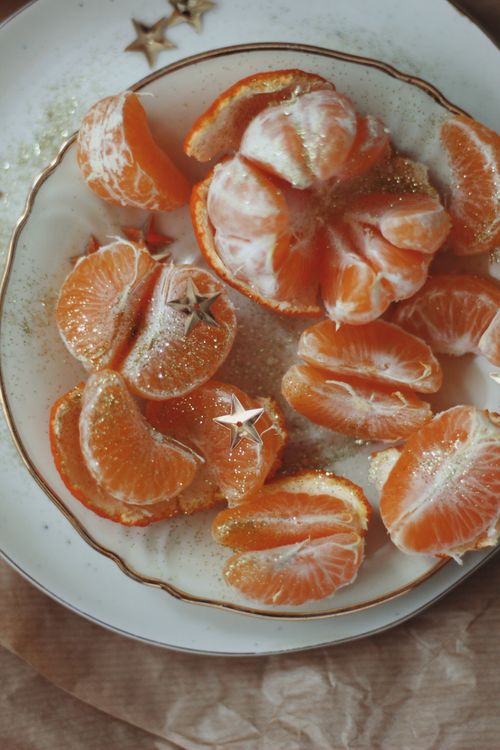 Free Fresh orange slices sprinkled with glittery stars for a festive touch. Stock Photo