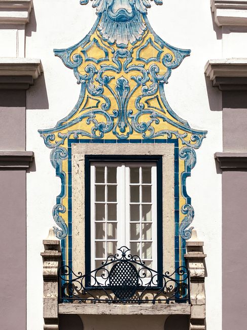 Detailed view of a traditional Portuguese tile-adorned window in Cascais, Lisbon.