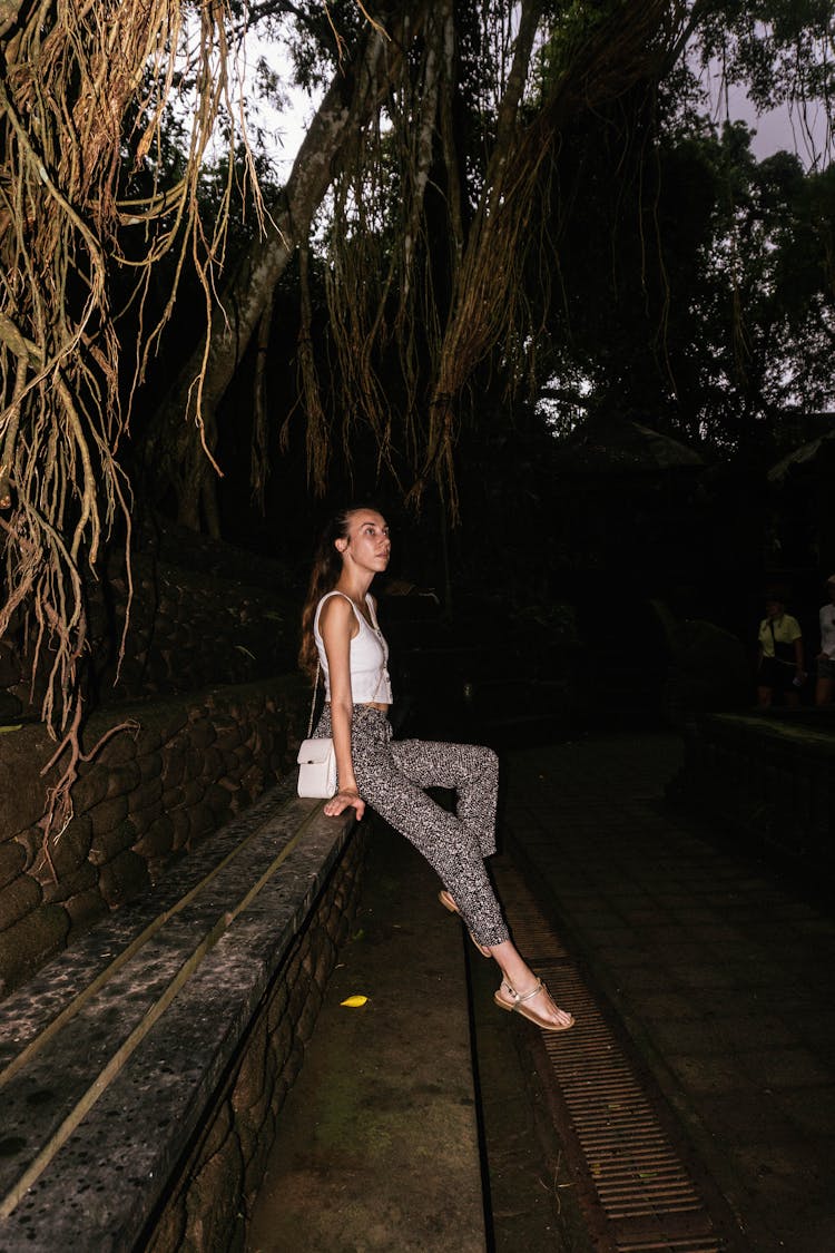 Woman Sitting In Park At Night