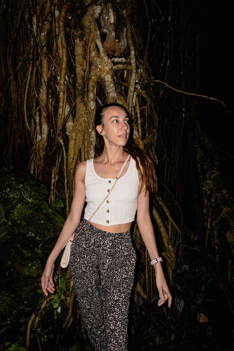 Woman Posing Near Old Tree At Night