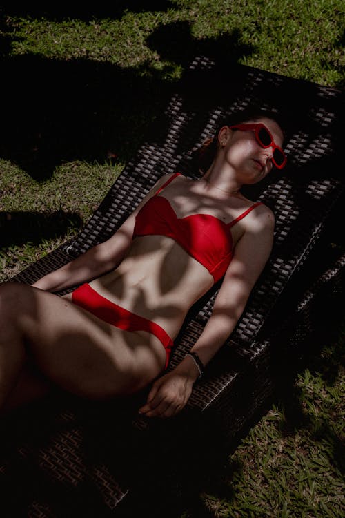 Woman in Red Bikini Lying on Lounge Chair