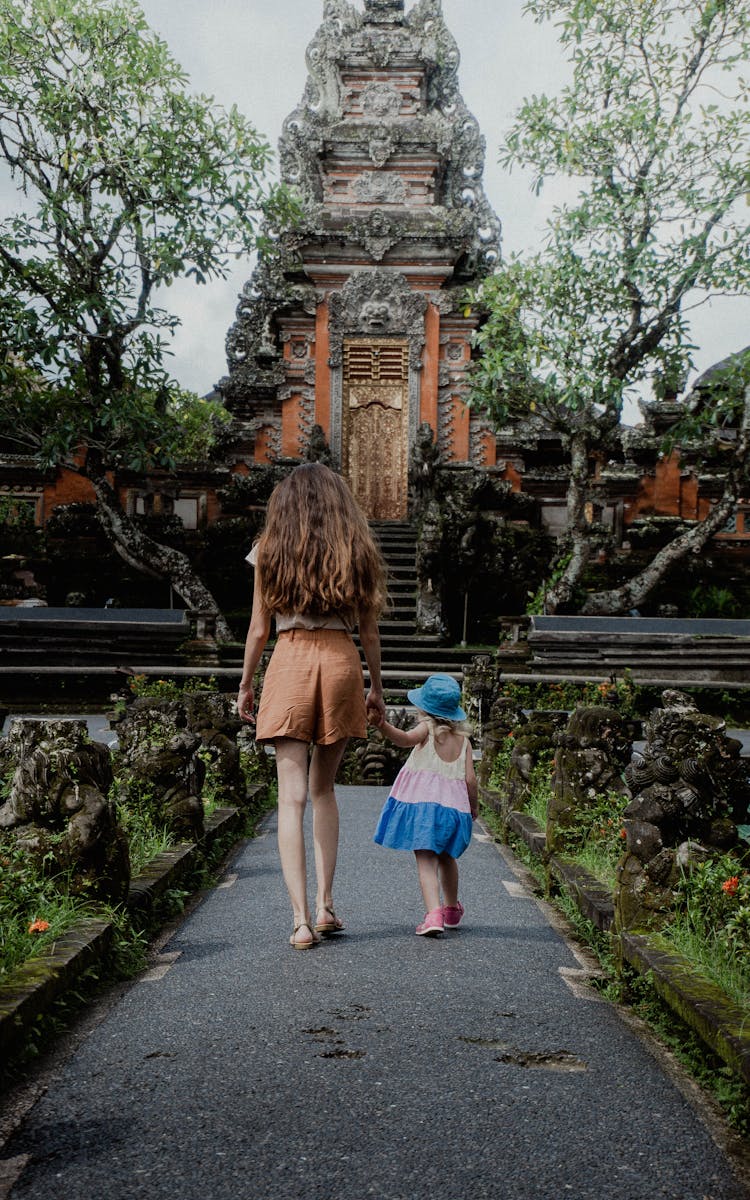 Girls Walking Near Traditional Old Temple