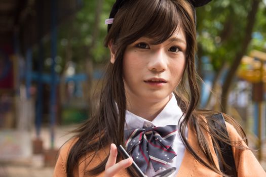 A young woman in cosplay attire posing outdoors, embodying a modern and stylish look.