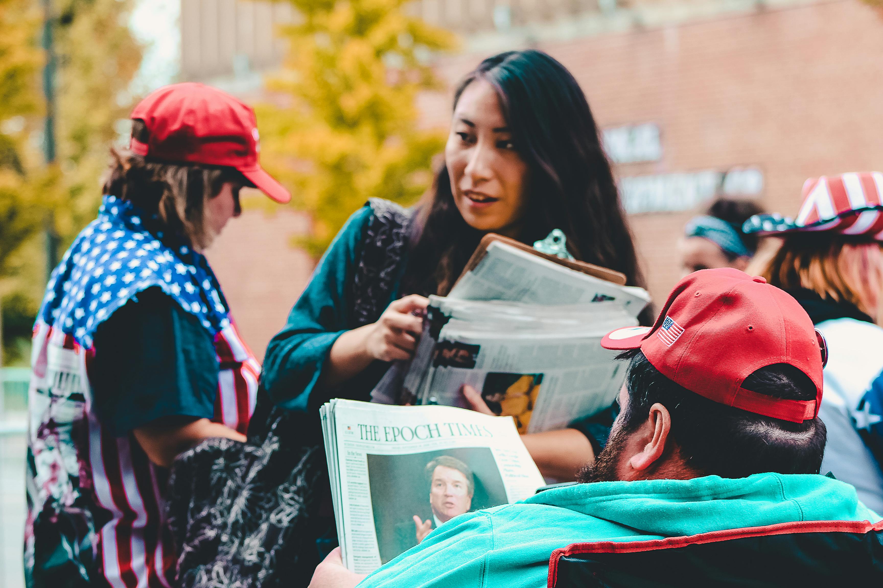 woman holding newspapers