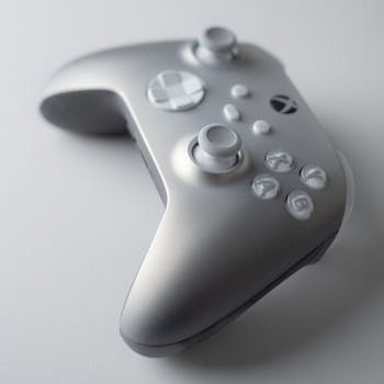 A stylish silver game controller with a modern design perfect for tech lovers.