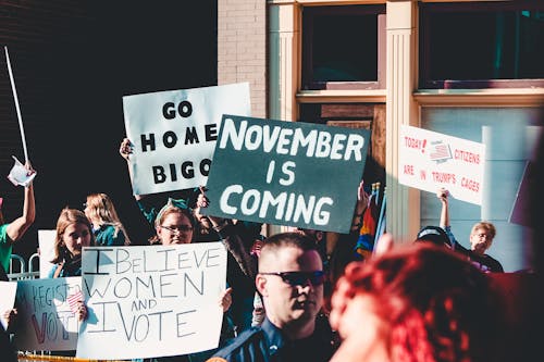 People Holding Banner Near Building