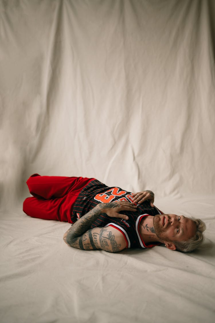 Man Lying Down In Basketball Tank Top