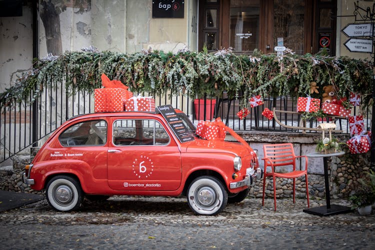 A Red Fiat 600 With Gift Boxes