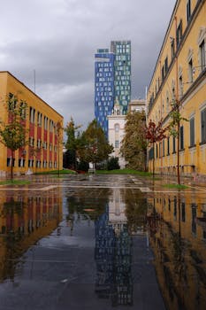 Dramatic urban scene with reflection in Tirana's cityscape after rain.