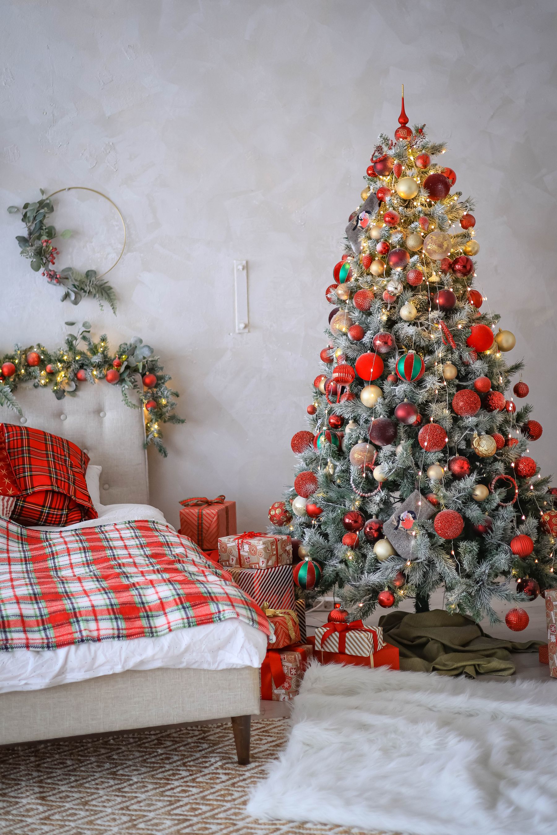 Christmas bedroom with tree wrapped gifts and warm festive lighting
