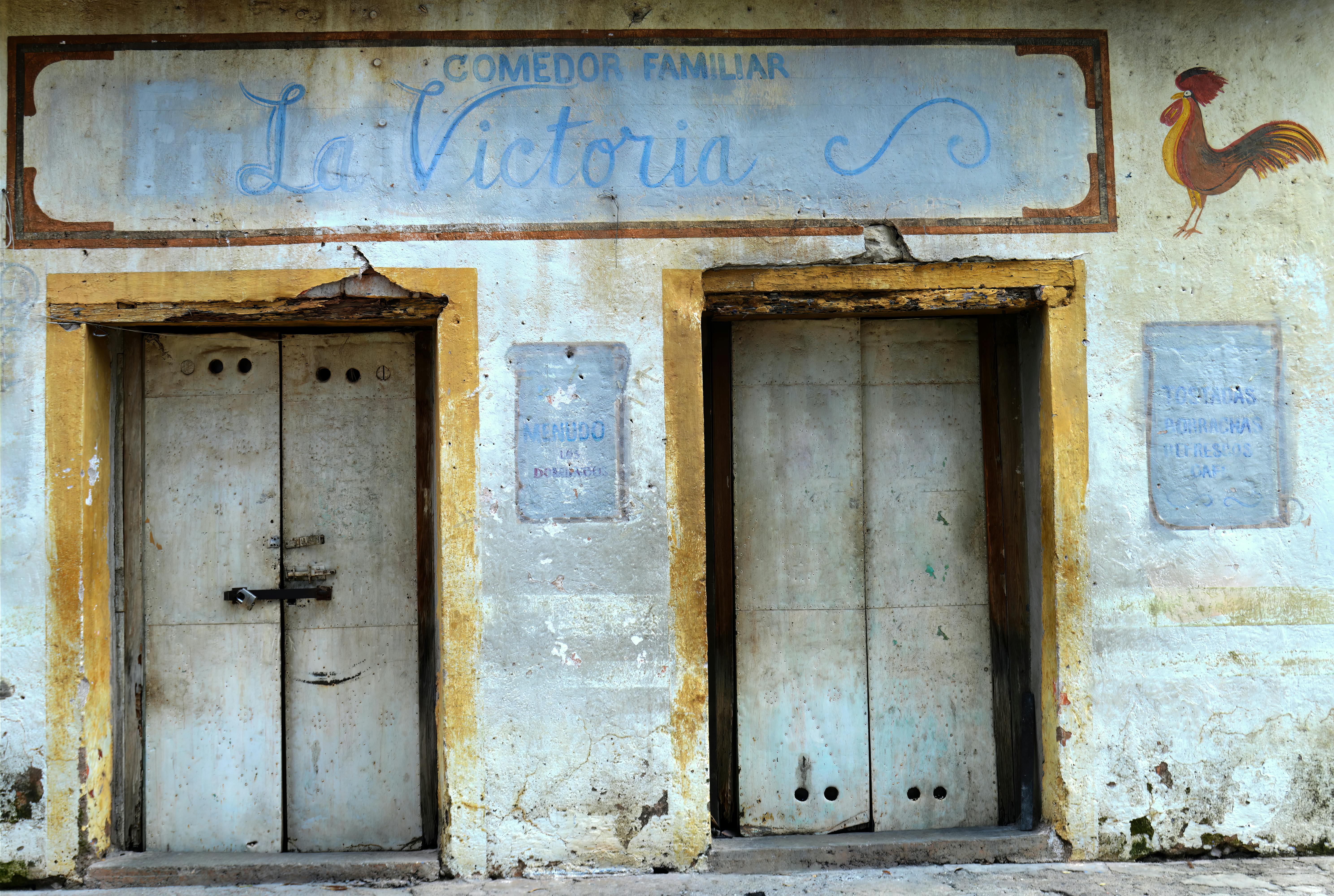 Historic La Victoria facade with rustic doors in Armadillo de los Infante, Mexico.