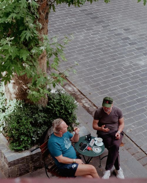 Free Two men enjoying coffee and conversation at a street café in Istanbul, Turkey. Stock Photo